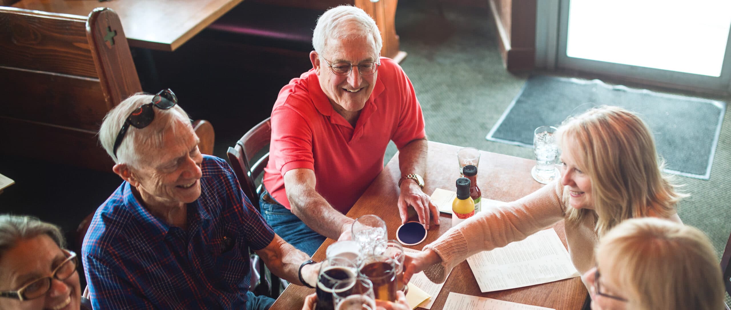 Senior Friends cheers at Happy Hour.